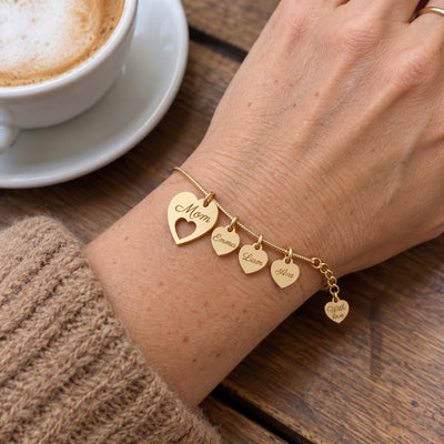 Gold Mom bracelet with children names worn on the wrist