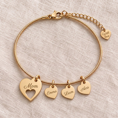 Gold heart name bracelet engraved Mom with kids names on linen