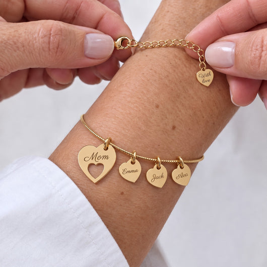 Fastening the gold heart name bracelet